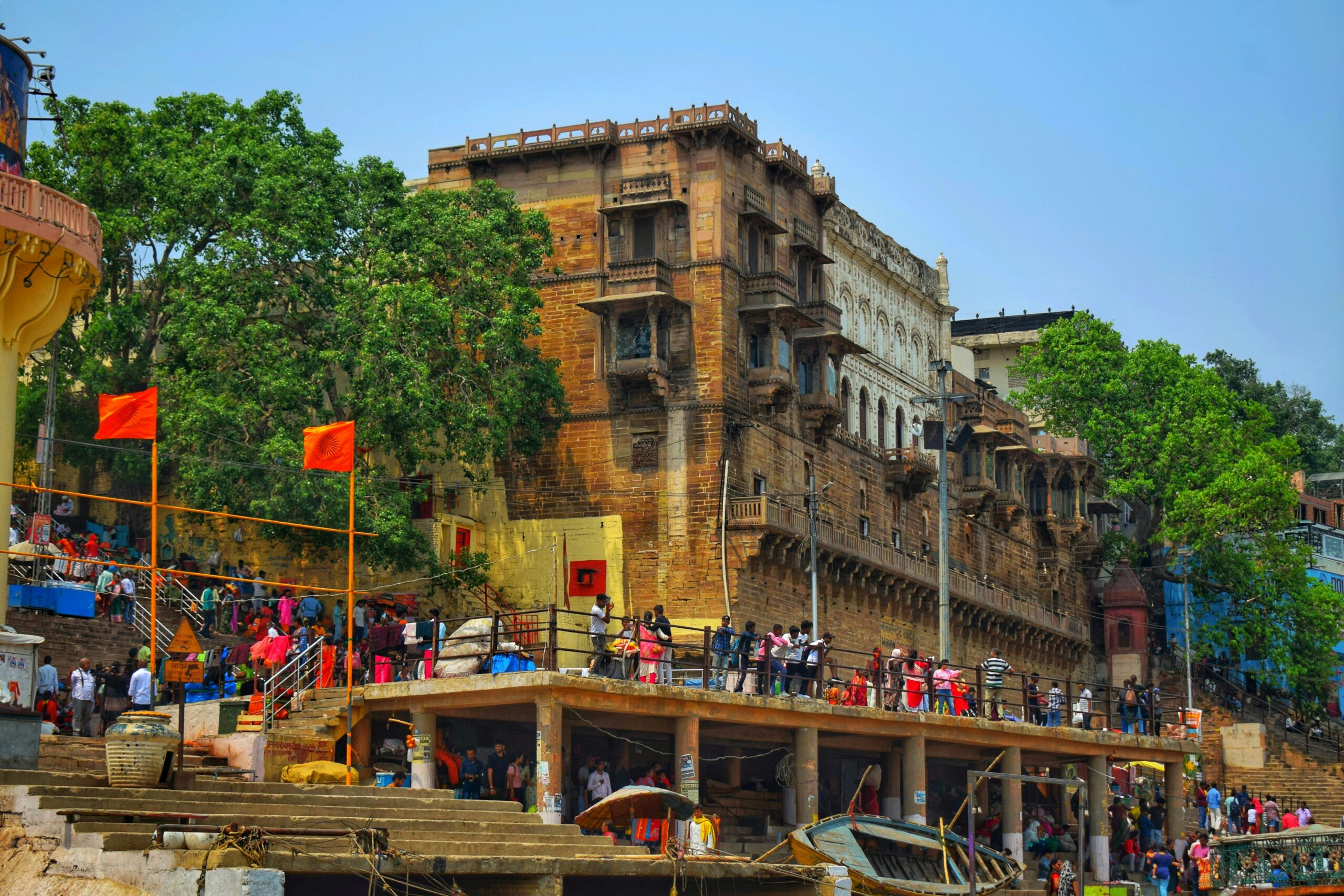 People gather at a historic ghat in Varanasi, Uttar Pradesh, India, showcasing cultural vibrancy.