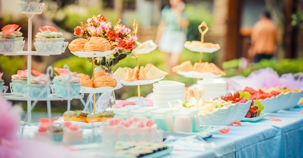 A vibrant outdoor buffet table showcasing an array of colorful pastries and fruits, perfect for parties.
